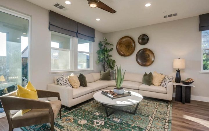 Cozy living room with a neutral color palette, contemporary furniture, and decorative wall plates in a modern home.